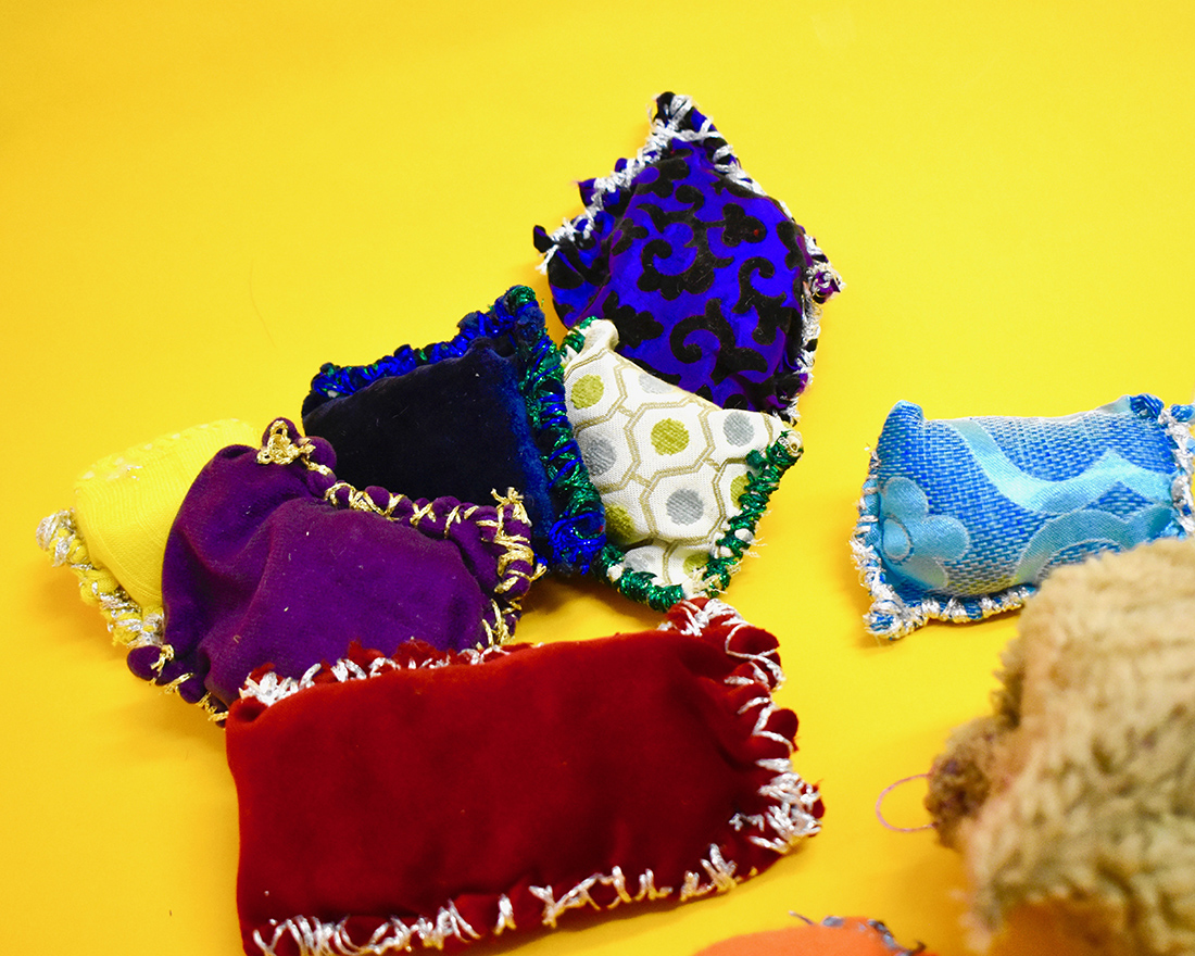 Small textile cushion like sculptures made from different coloured fabrics