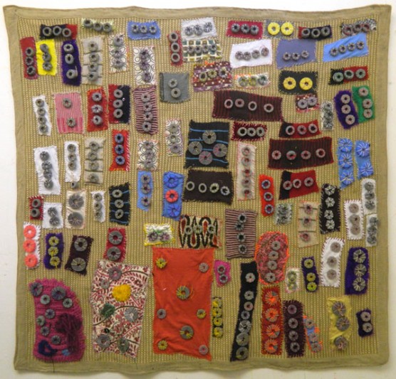 Large textile work made up of small coloured pieces of fabric
