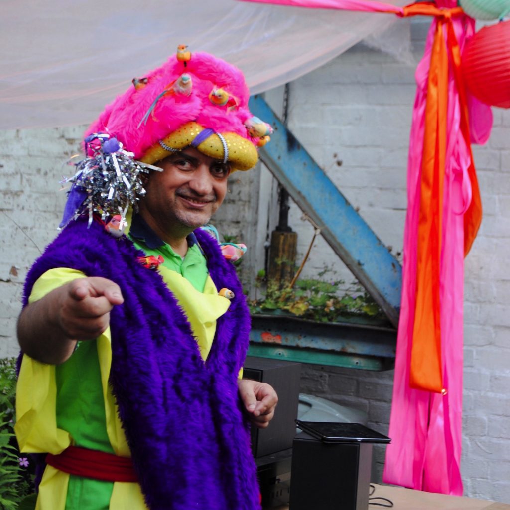Pardip Kapil wearing a brightly coloured outfit and headdress for Pop Up Pardip