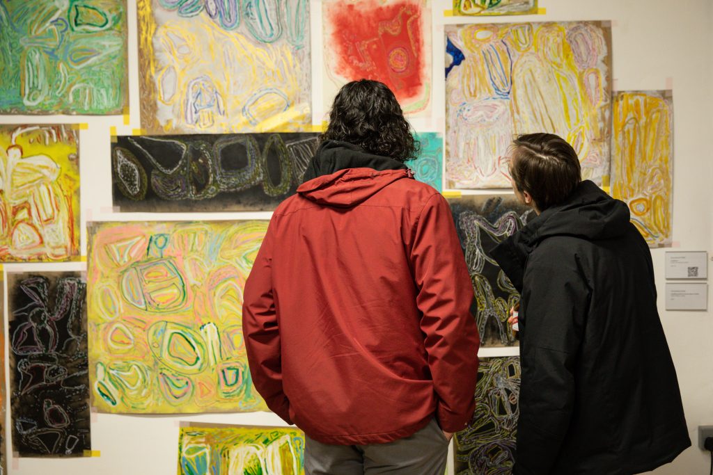 Two people looking at Chandrakant Patel's installation