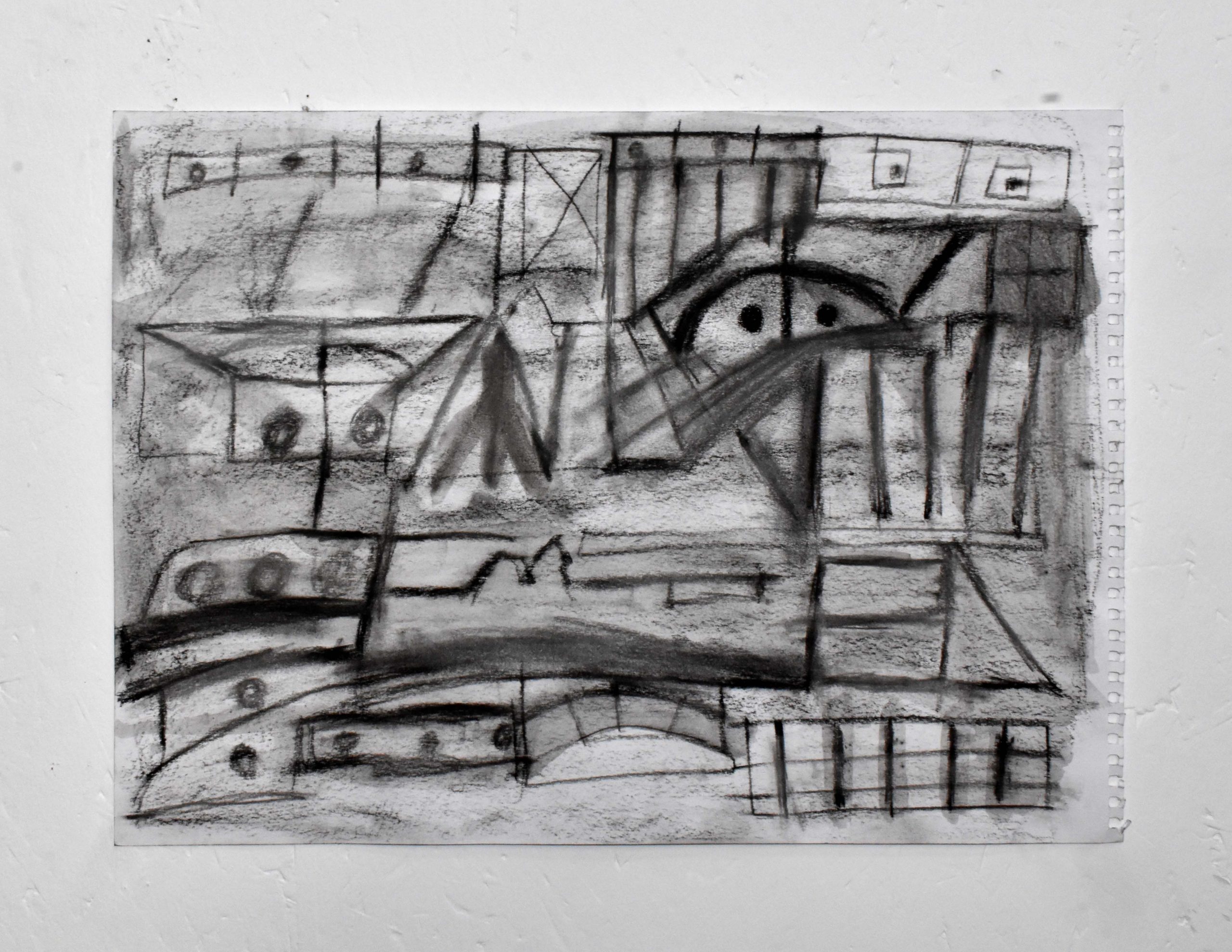An image of a small, rectangle, abstract drawing in black charcoal. Gestural strokes suggesting bridges, pathways and other abstract forms appear.