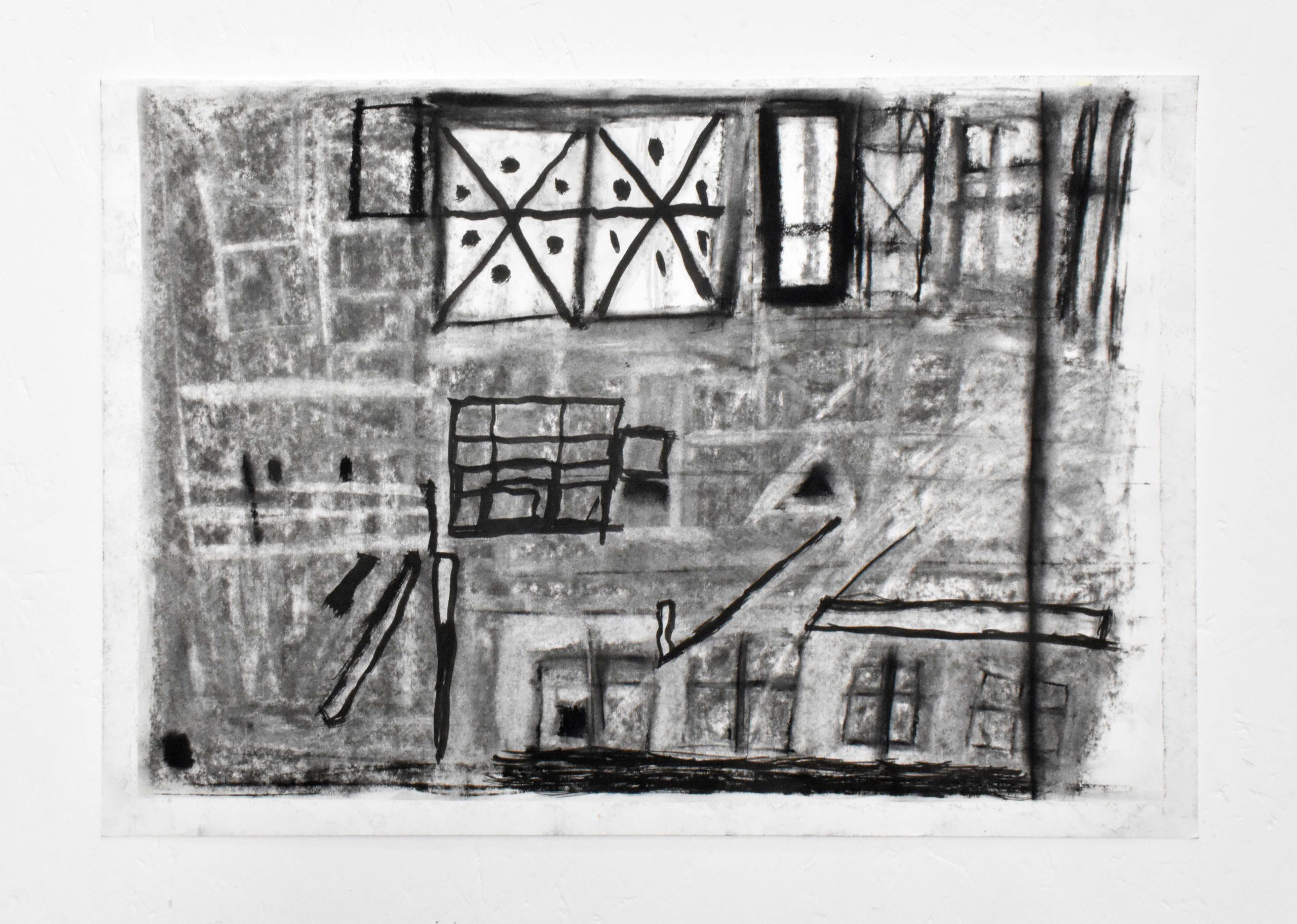 An image of a small, rectangle, drawing in black charcoal. Windows emerge from abstract shapes ,lines, and shadows.