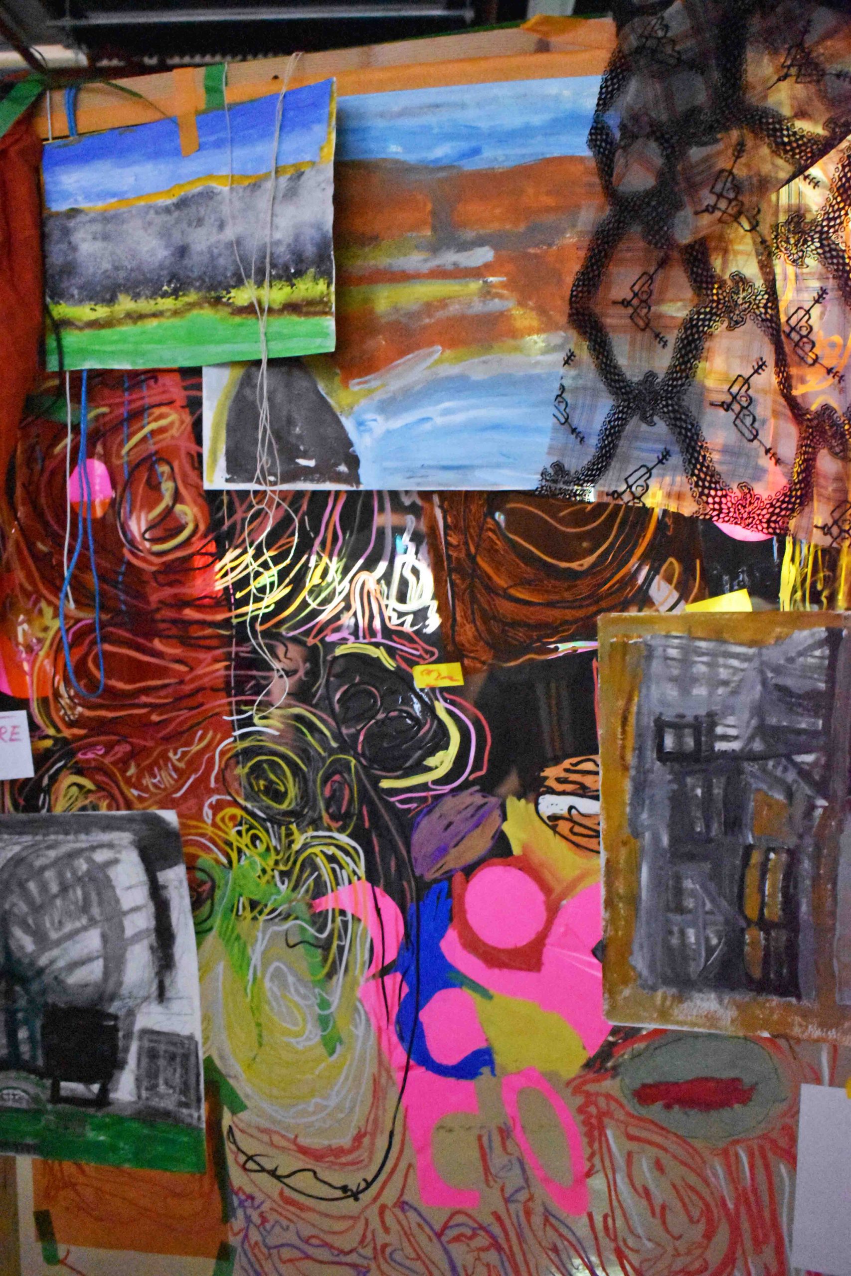 Mixed media, colourful installation hung on a wooden tall stand. 