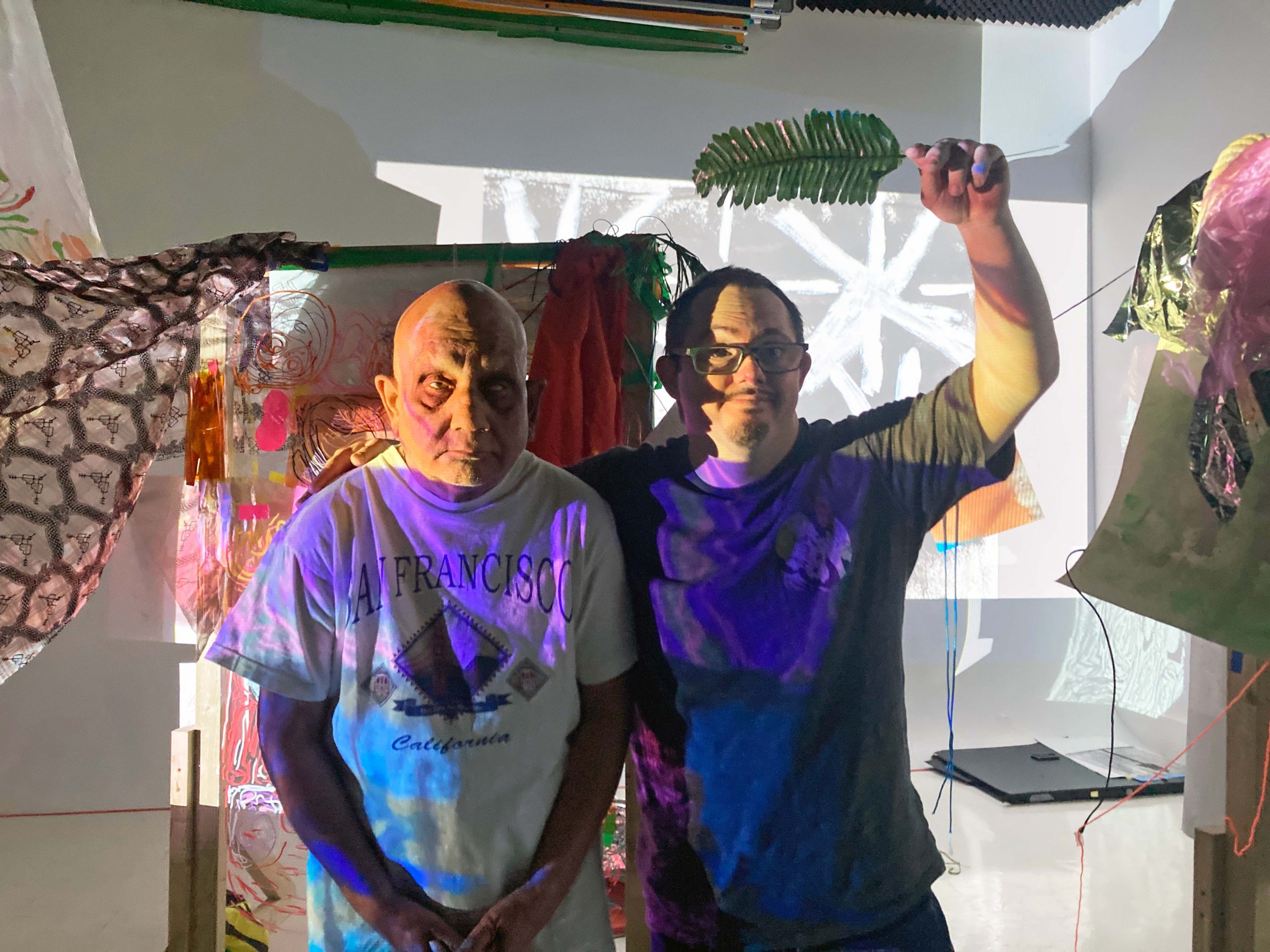 ActionSpace artists Chandrakant Patel and James Heath smile for a photo in front of their installation.