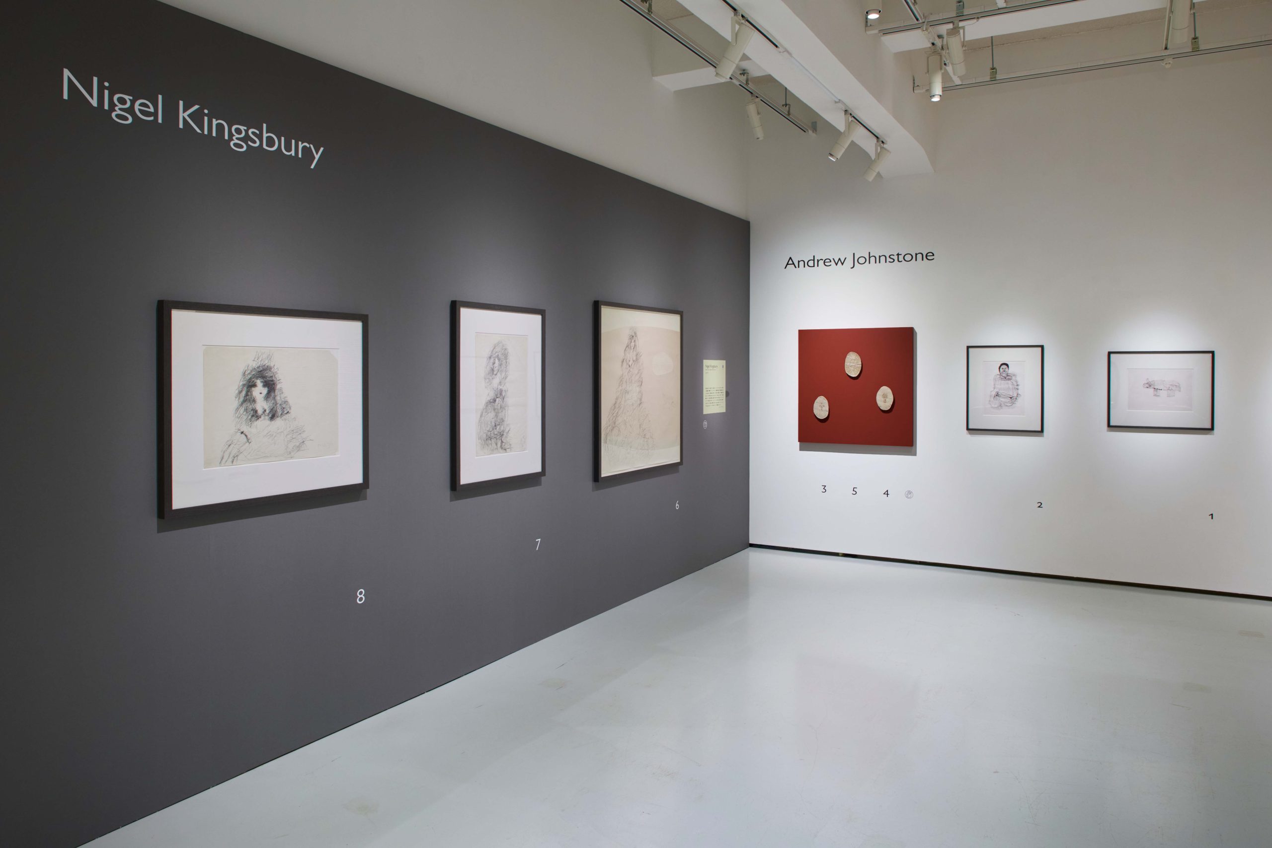4 small and medium, simple, pencil drawings are installed in black frames on a black gallery wall. 'Nigel Kingsbury' reads on top left. A wall to the right features another artist with framed works.