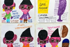 Four abstract square drawings hung on a white wall, capital text, funky characters and hair products drawn in marker.